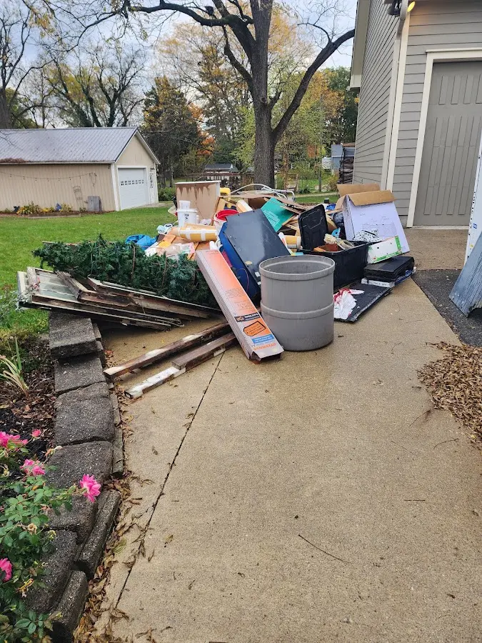 Dumpster being loaded with debris for 12 Yard Dumpster Rental in Fairlawn